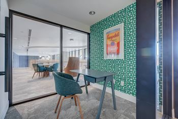 A room with a green chair and a green table.